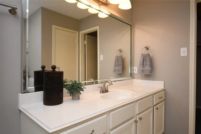a bathroom with a sink a vanity and a mirror