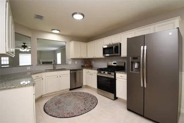 a kitchen with a refrigerator stove and microwave