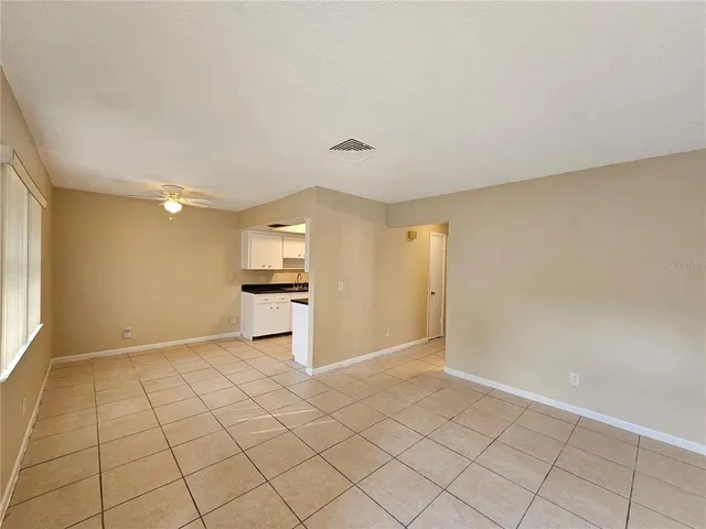a view of a kitchen with a sink and a refrigerator