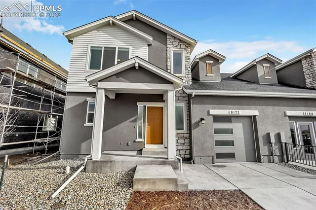 a view of a white house with large windows