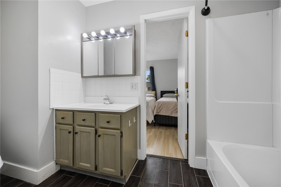 597 French Road Brighton, NY 14618 - Photo 16 of 24 Updated full bath with a view to the second bedroom.