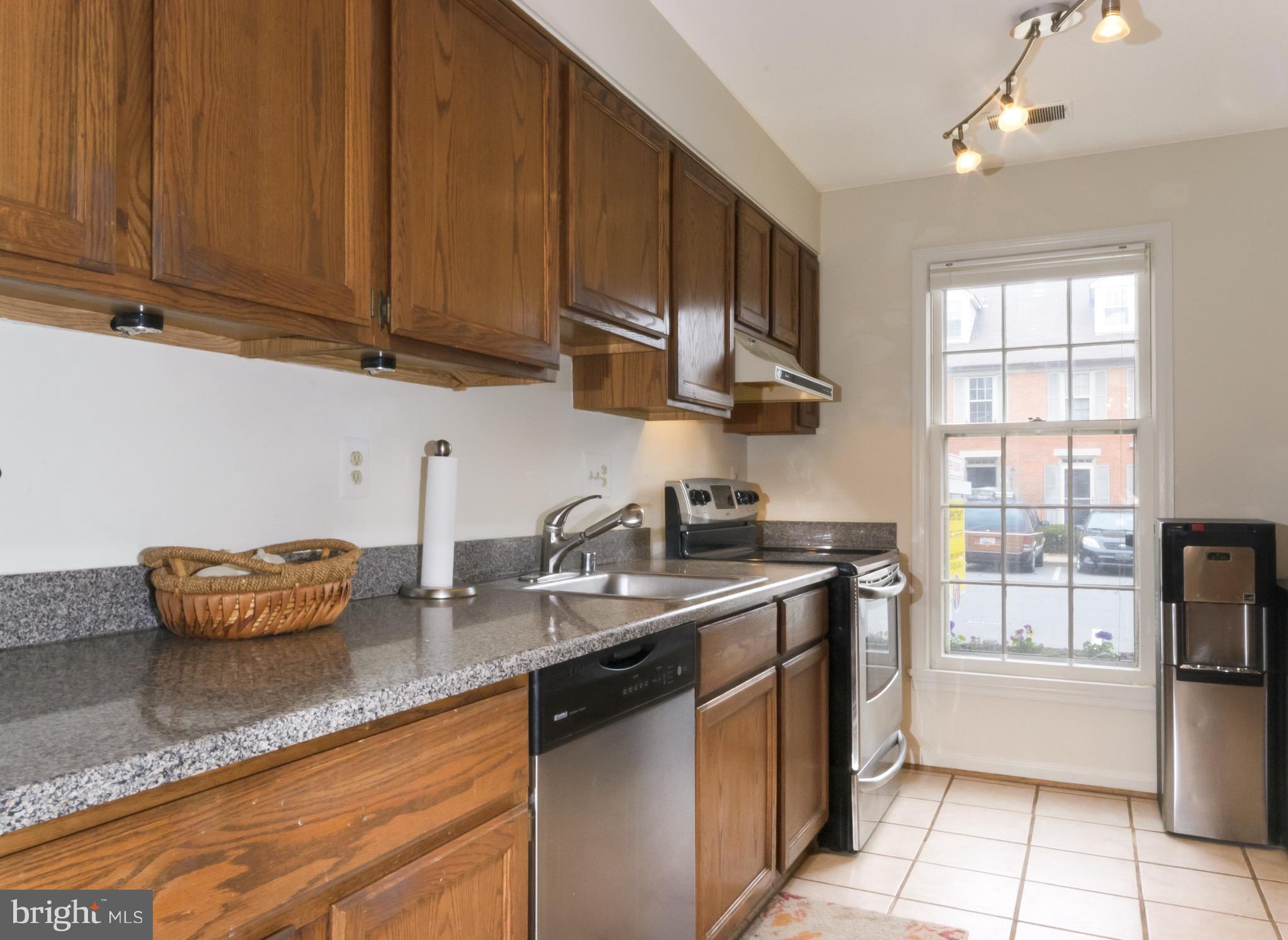 428 West Glebe Road Alexandria, VA 22305 - Photo 4 of 25 a kitchen with stainless steel appliances granite countertop a sink stove and cabinets