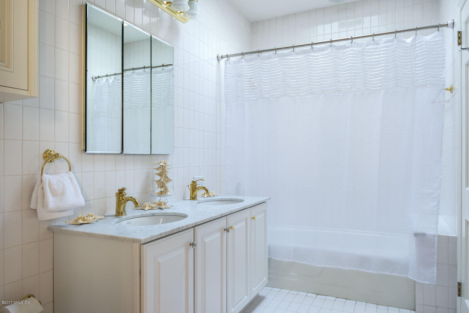 25 Windabout Drive Greenwich, CT 06831 - Photo 18 of 31 a bathroom with a sink and a shower