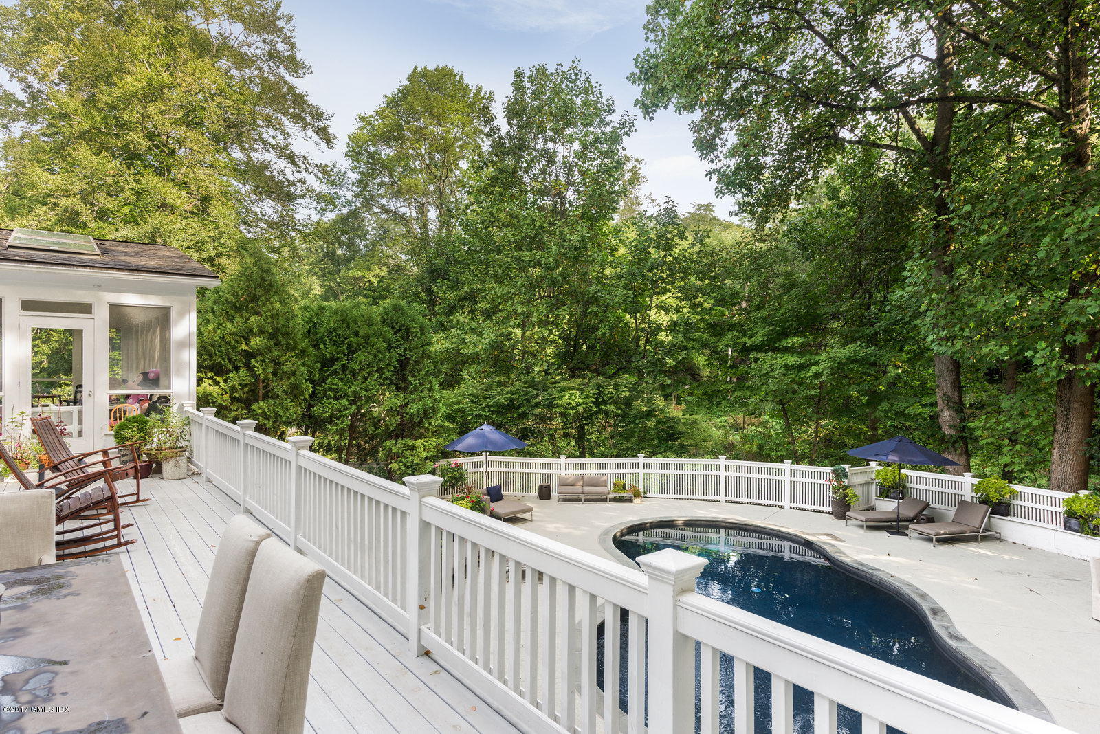25 Windabout Drive Greenwich, CT 06831 - Photo 29 of 31 a view of a patio with a table and chairs with wooden fence and plants