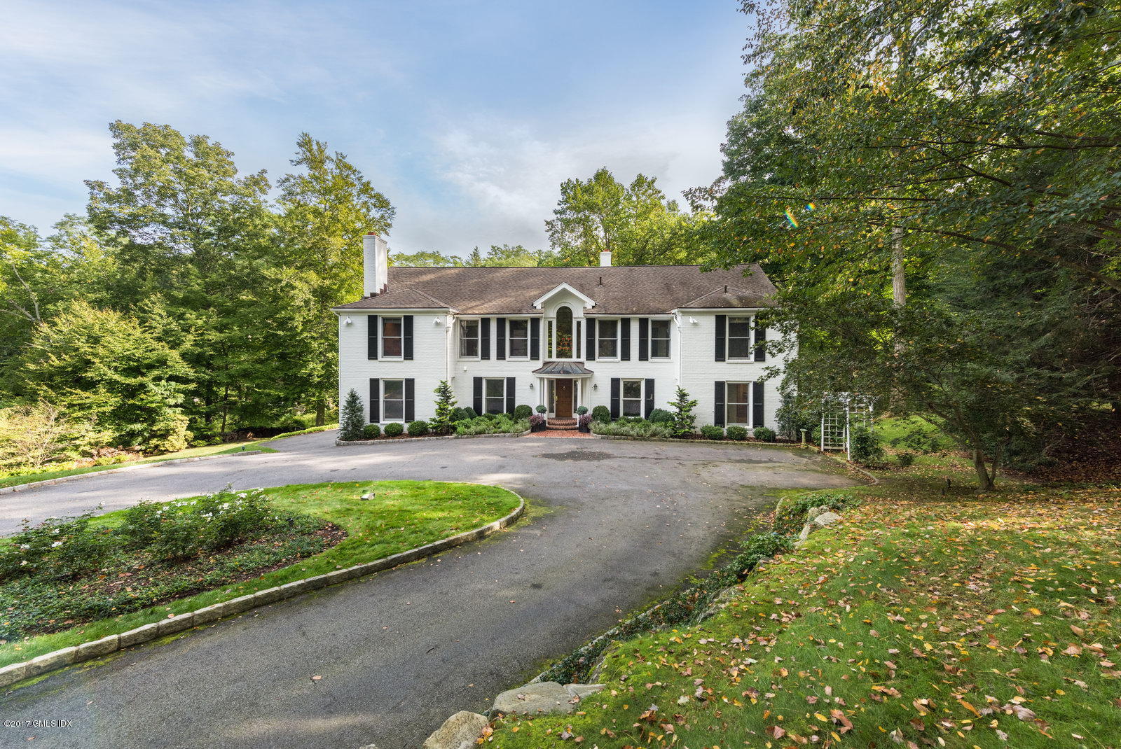 25 Windabout Drive Greenwich, CT 06831 - Photo 31 of 31 a front view of a house with a yard table and chairs