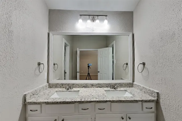 en empty room with windows and fan