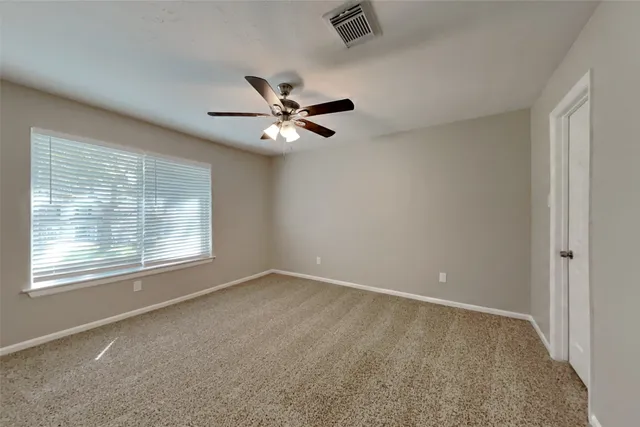 a bathroom with a granite countertop toilet a sink and a mirror