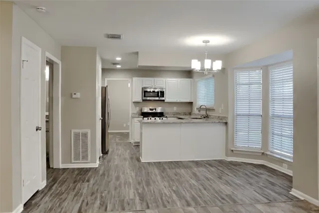a kitchen with stainless steel appliances a refrigerator sink and cabinets
