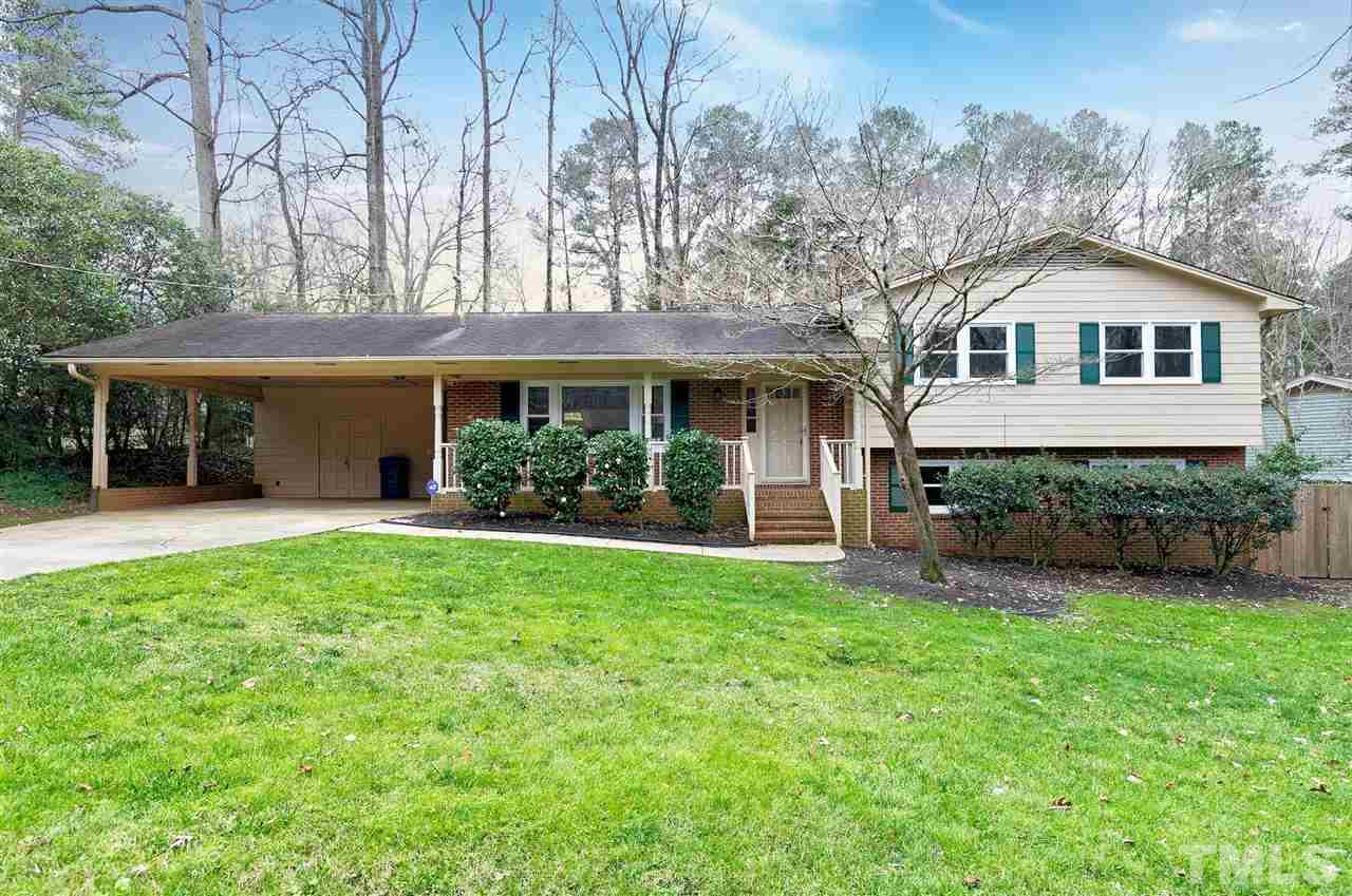 6509 Wrenwood Avenue Raleigh, NC 27607 - Photo 1 of 29 a front view of a house with a garden and yard