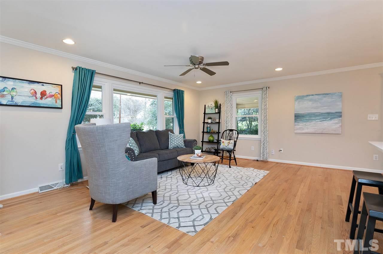 6509 Wrenwood Avenue Raleigh, NC 27607 - Photo 2 of 29 a living room with furniture and a wooden floor