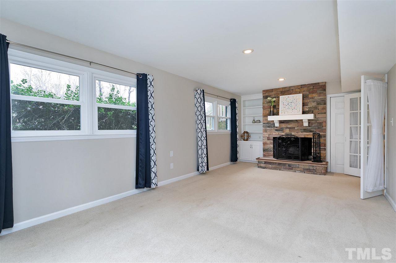 6509 Wrenwood Avenue Raleigh, NC 27607 - Photo 14 of 29 an empty room with furniture and a fireplace
