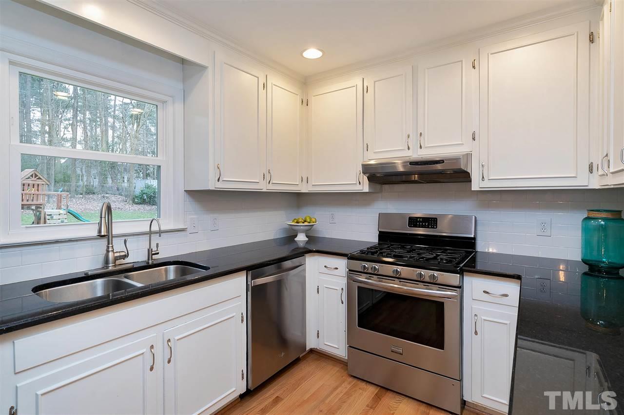 6509 Wrenwood Avenue Raleigh, NC 27607 - Photo 7 of 29 a kitchen with stainless steel appliances granite countertop a sink a stove and a microwave