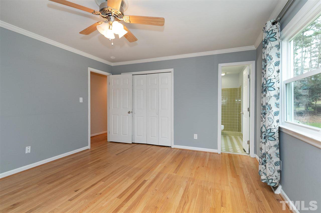 6509 Wrenwood Avenue Raleigh, NC 27607 - Photo 8 of 29 a view of empty room with wooden floor and fan