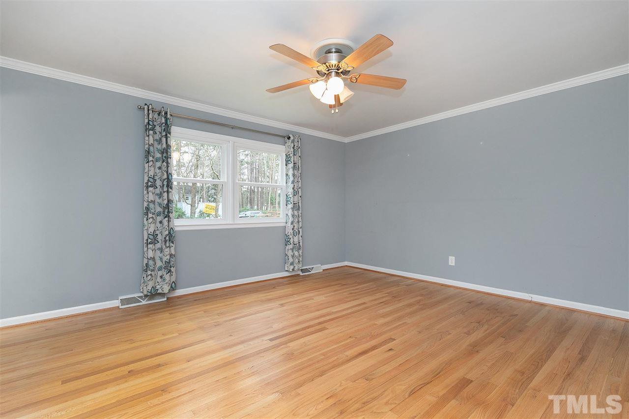 6509 Wrenwood Avenue Raleigh, NC 27607 - Photo 9 of 29 wooden floor in an empty room with a window