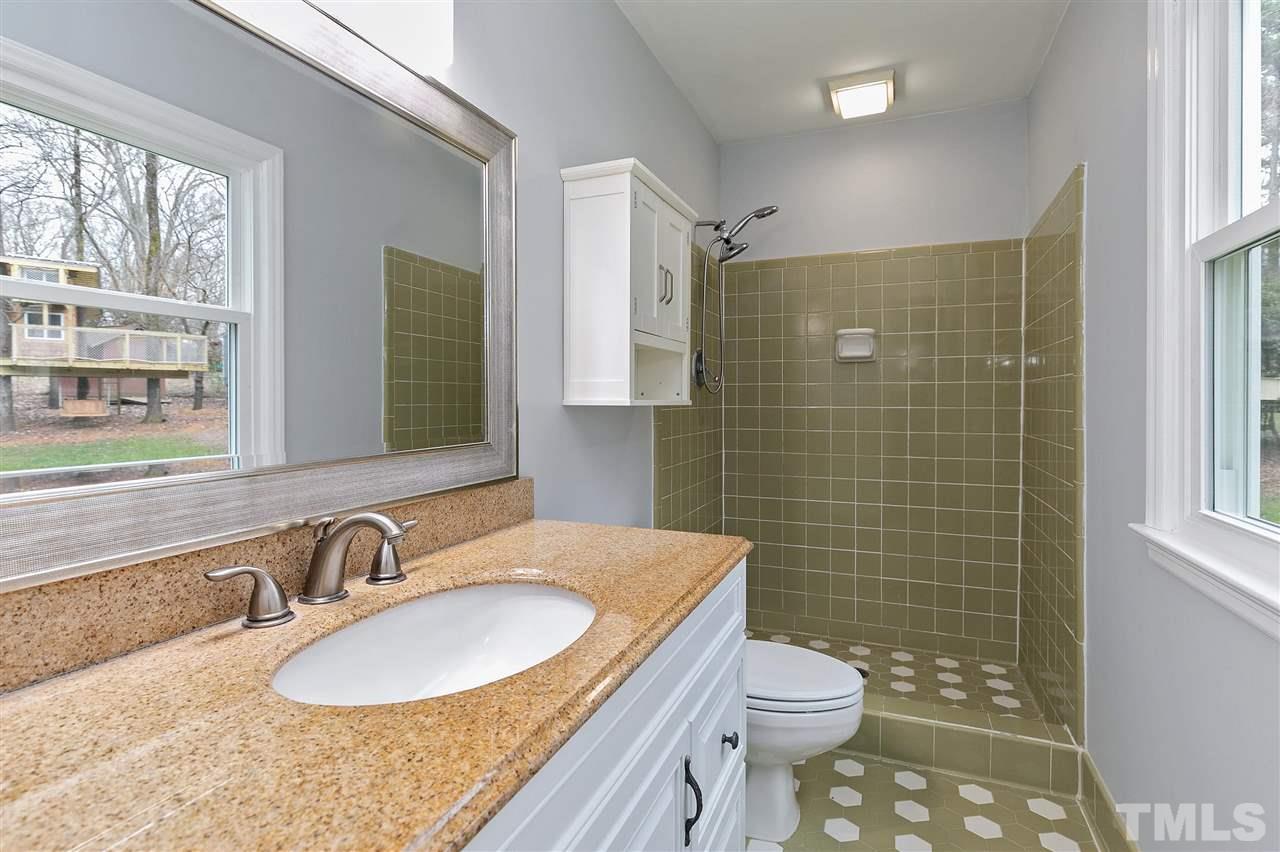 6509 Wrenwood Avenue Raleigh, NC 27607 - Photo 10 of 29 a bathroom with a granite countertop sink toilet and shower