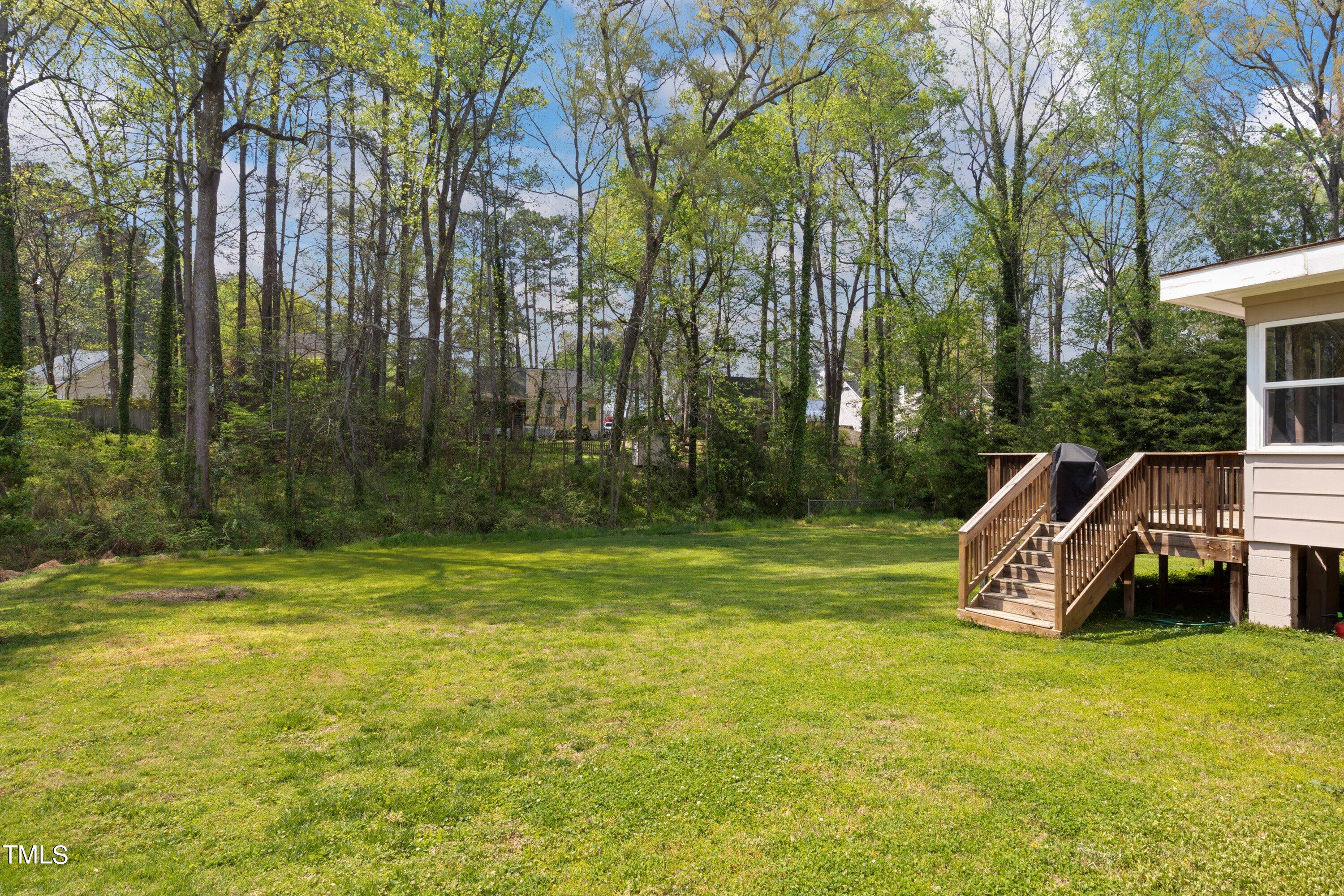 4720 Greenbrier Road Raleigh, NC 27603 - Photo 37 of 39 a view of a swimming pool with a garden and trees