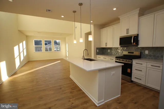 a kitchen with granite countertop a stove and a sink