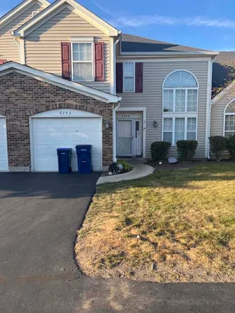 a view of a house with swimming pool in front of it