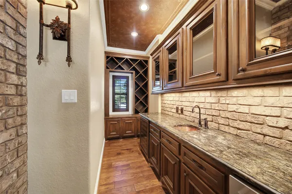 a view of empty room with wooden floor and ceiling fan