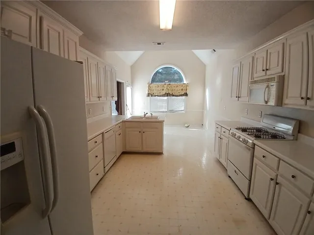 a view of a kitchen with sink and cabinets