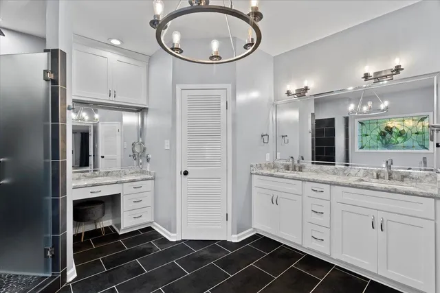a bathroom with a double vanity sink a mirror and a shower