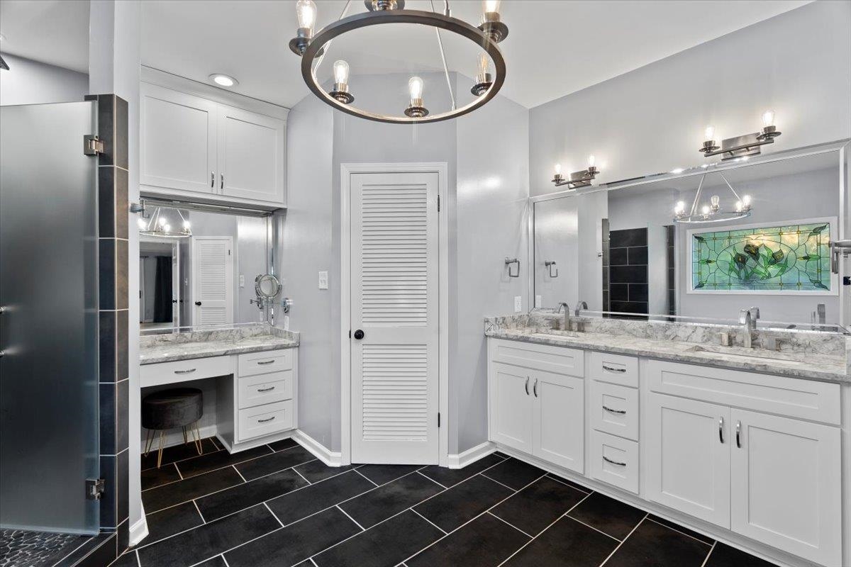 8485 Highway 196 Collierville, TN 38017 - Photo 11 of 34 a bathroom with a double vanity sink a mirror and a shower
