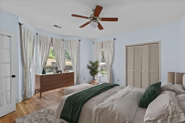 a bedroom with a bed and a chandelier