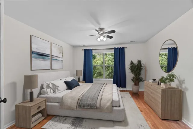 a bedroom with a large bed and a chandelier