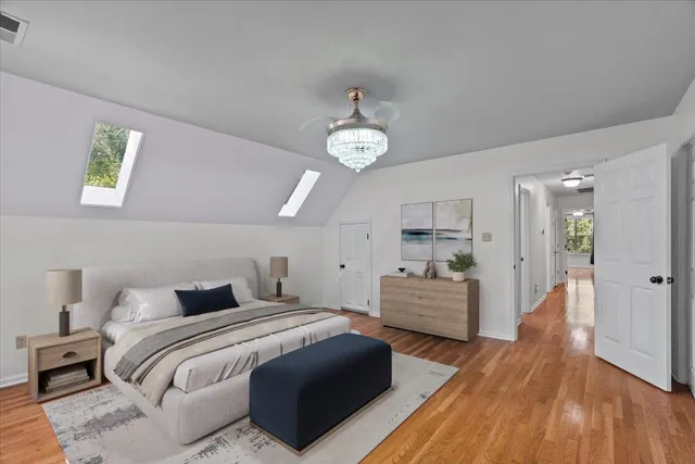 a bedroom with a bed and a chandelier