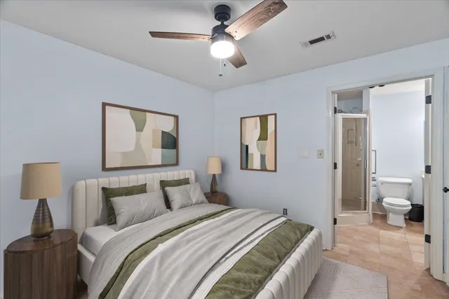 a bedroom with a bed and a painting on the wall