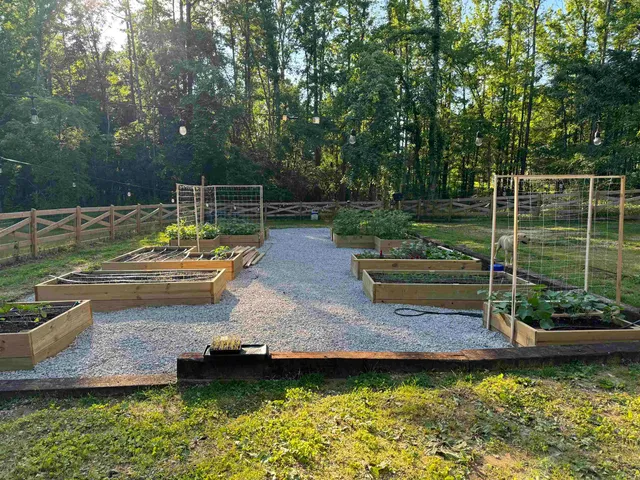 a view of a swimming pool with a garden and sitting area