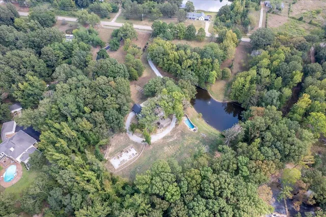 an aerial view of a house with a yard and lake view