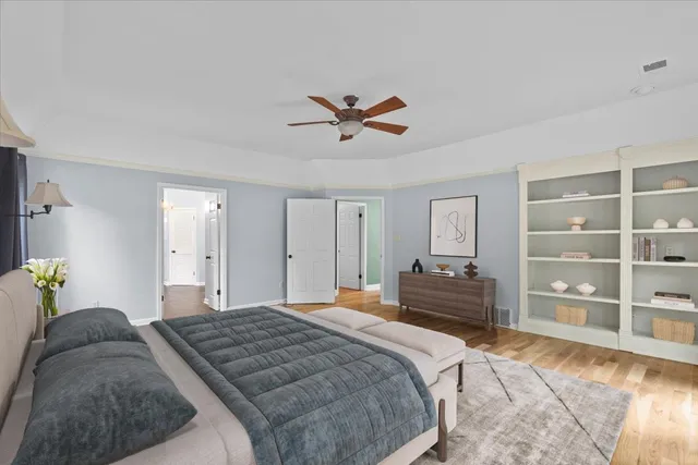 a bedroom with a bed and dresser with mirror