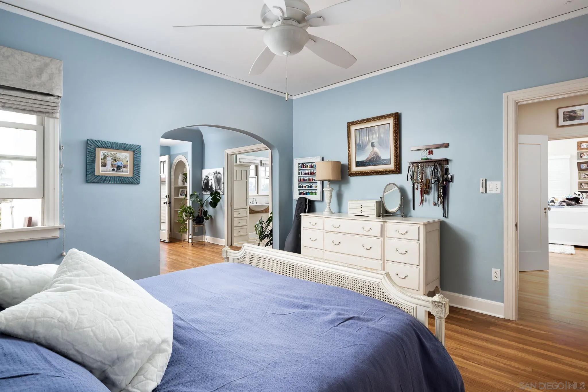 4192 Rochester Road San Diego, CA 92116 - Photo 17 of 49 a bedroom with a bed and a chandelier