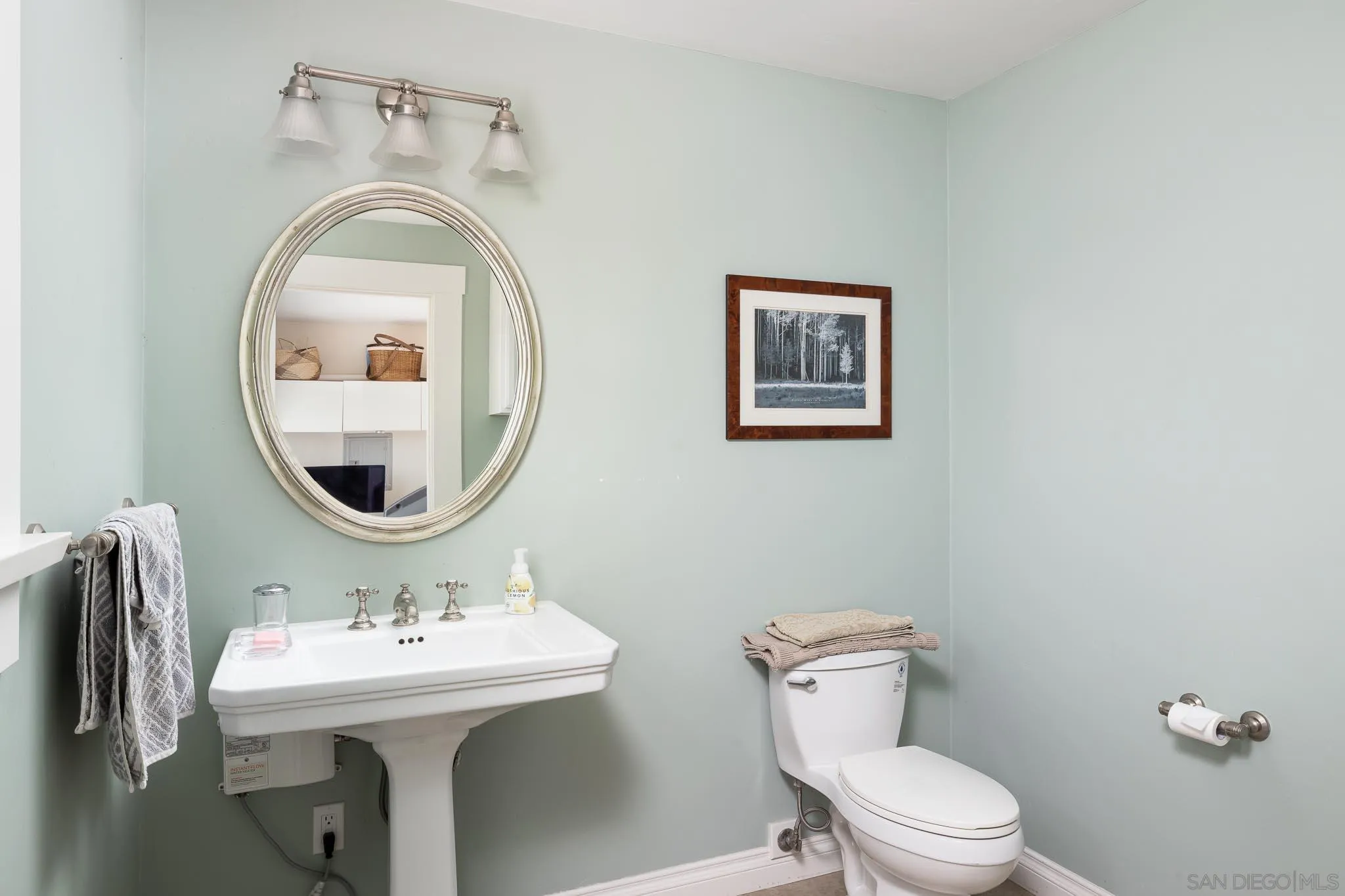 4192 Rochester Road San Diego, CA 92116 - Photo 30 of 49 a bathroom with a toilet sink and mirror