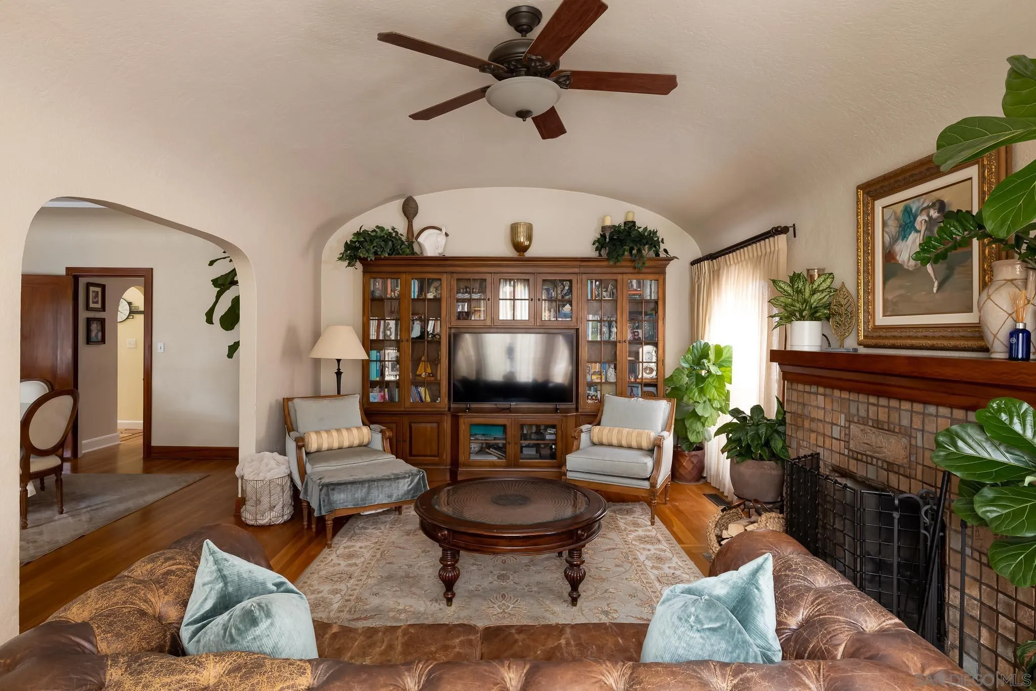 4192 Rochester Road San Diego, CA 92116 - Photo 3 of 49 a living room with furniture a fireplace and a chandelier
