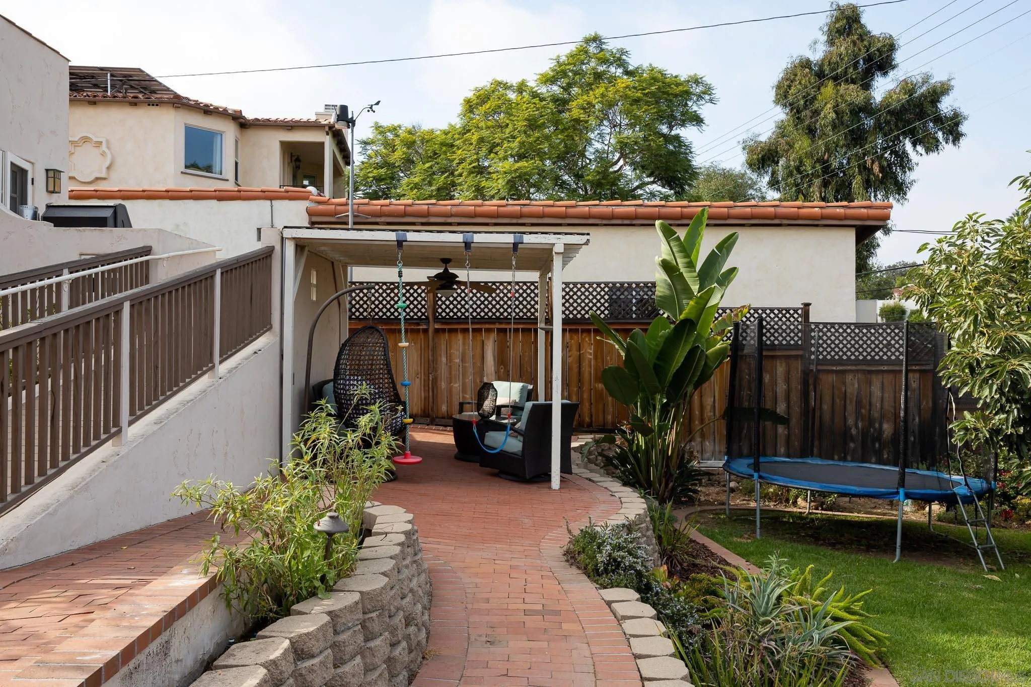 4192 Rochester Road San Diego, CA 92116 - Photo 32 of 49 a view of a chair and tables in the back yard of the house