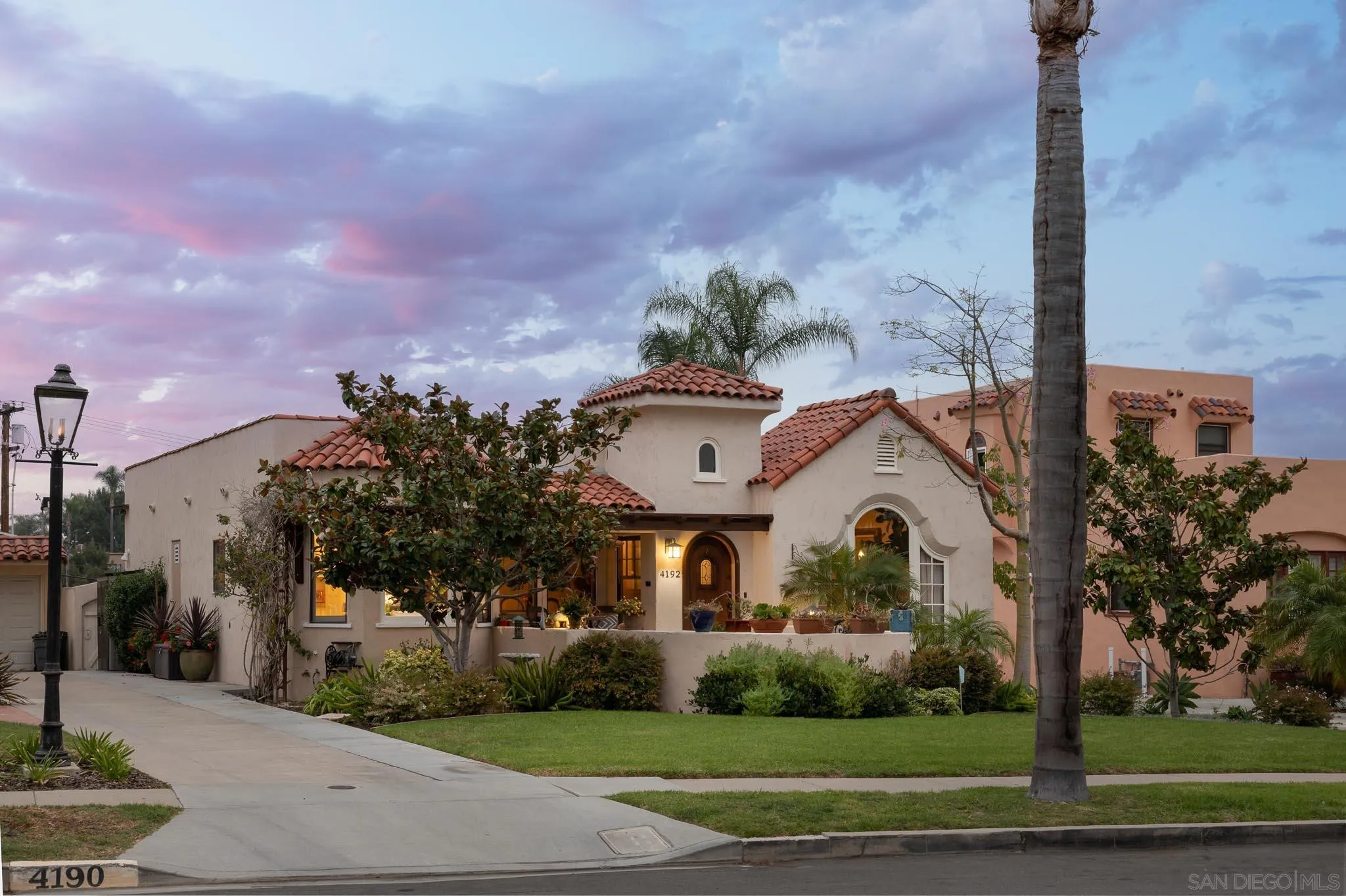 4192 Rochester Road San Diego, CA 92116 - Photo 38 of 49 a view of a white house with a clock and a yard