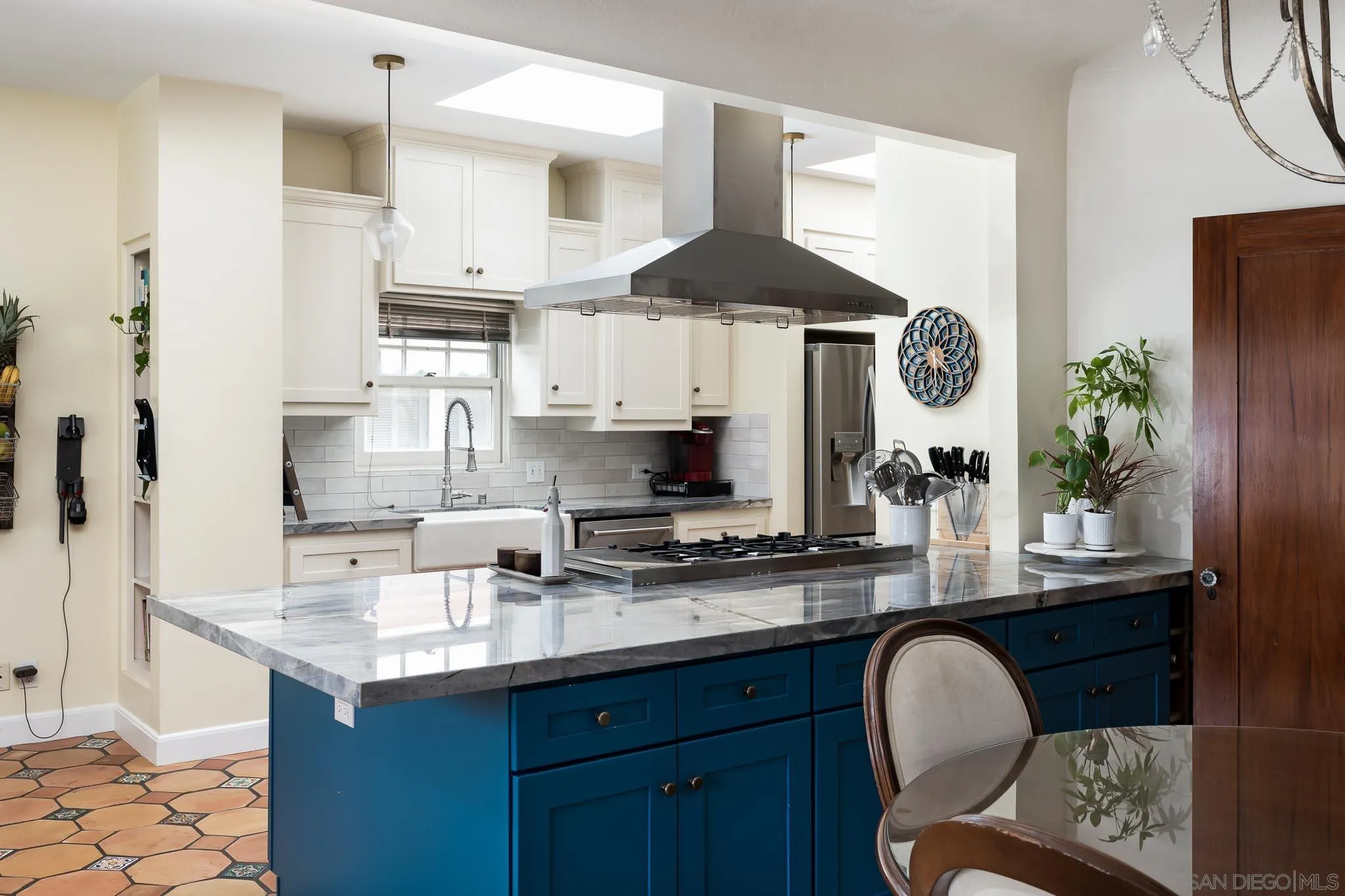4192 Rochester Road San Diego, CA 92116 - Photo 9 of 49 a kitchen with stainless steel appliances a sink a stove and a wooden floors