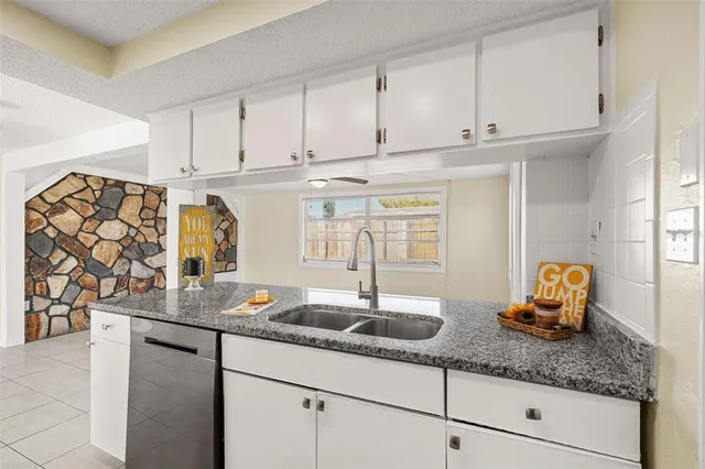 a kitchen with stainless steel appliances granite countertop a sink and cabinets