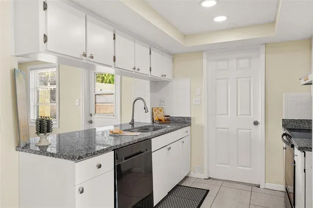 a kitchen with stainless steel appliances granite countertop a sink and cabinets