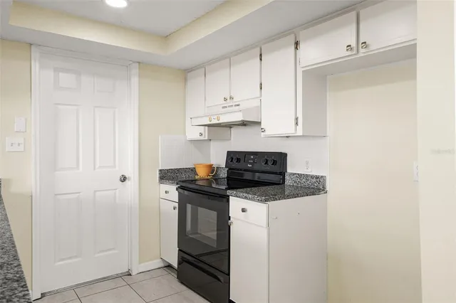 a kitchen with stainless steel appliances granite countertop a sink and a stove