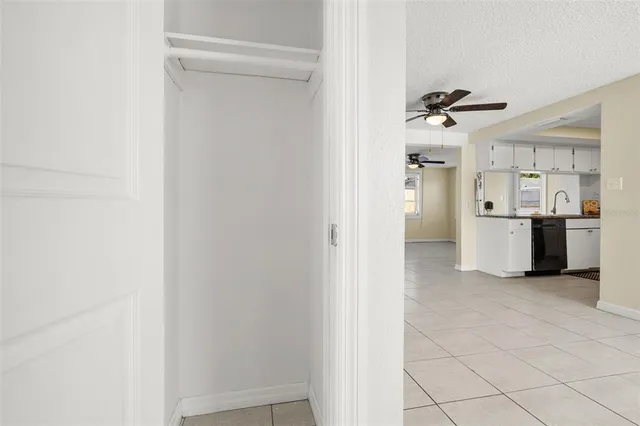 a view of a hallway with a kitchen