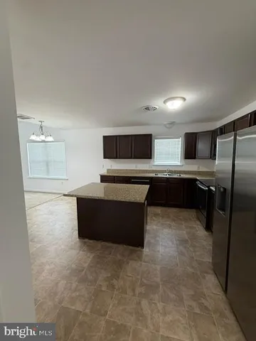 a large kitchen with cabinets and stainless steel appliances