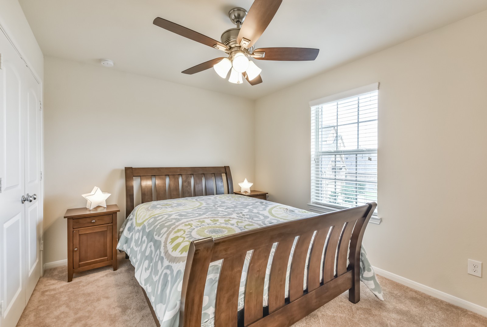 10003 Open Slope Court Humble, TX 77396 - Photo 11 of 25 Another secondary bedroom with ceiling fan and window coverings.