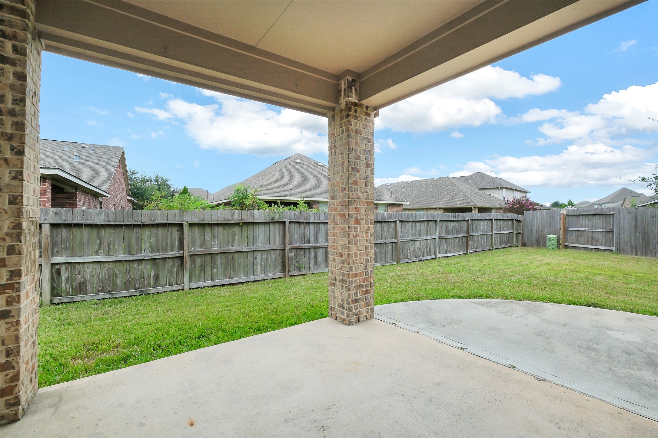 10003 Open Slope Court Humble, TX 77396 - Photo 15 of 25 Large covered patio with side extension for lots of seating options.