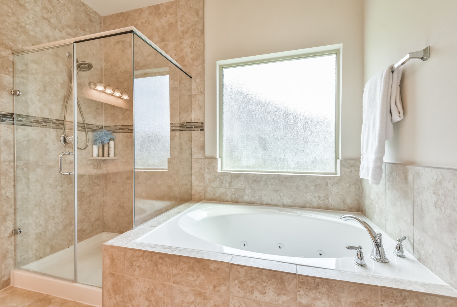 10003 Open Slope Court Humble, TX 77396 - Photo 9 of 25 The primary bathroom has been upgraded with an oversized jetted tub and separate glass framed shower. Waterfall glass window provides light and privacy.