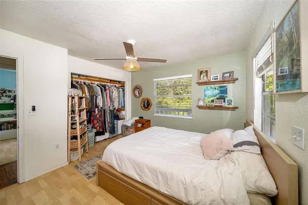 a view of a room with wooden floor and a chandelier