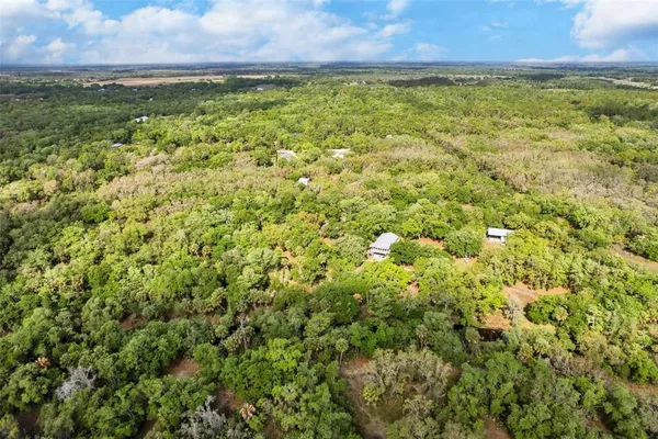 a backyard of a house with a yard and outdoor seating