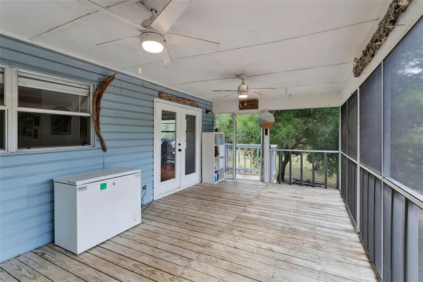 a view of a balcony with wooden floor and outdoor space